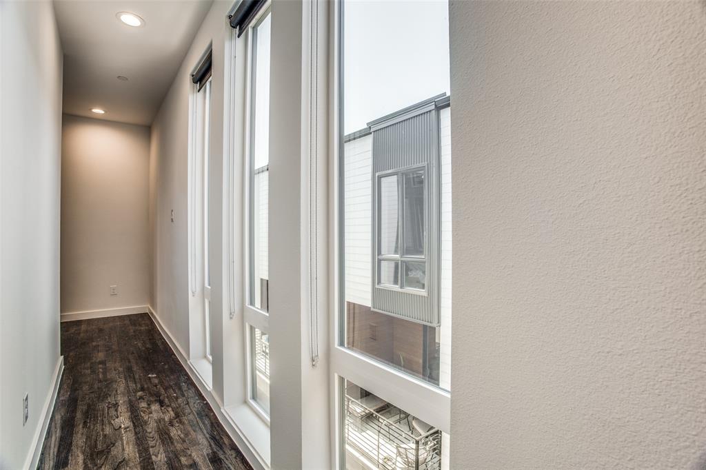 2180 Bennett Avenue, Unit 303 Dallas, TX 75206 - Photo 12 of 24 a view of a hallway with wooden floor and staircase
