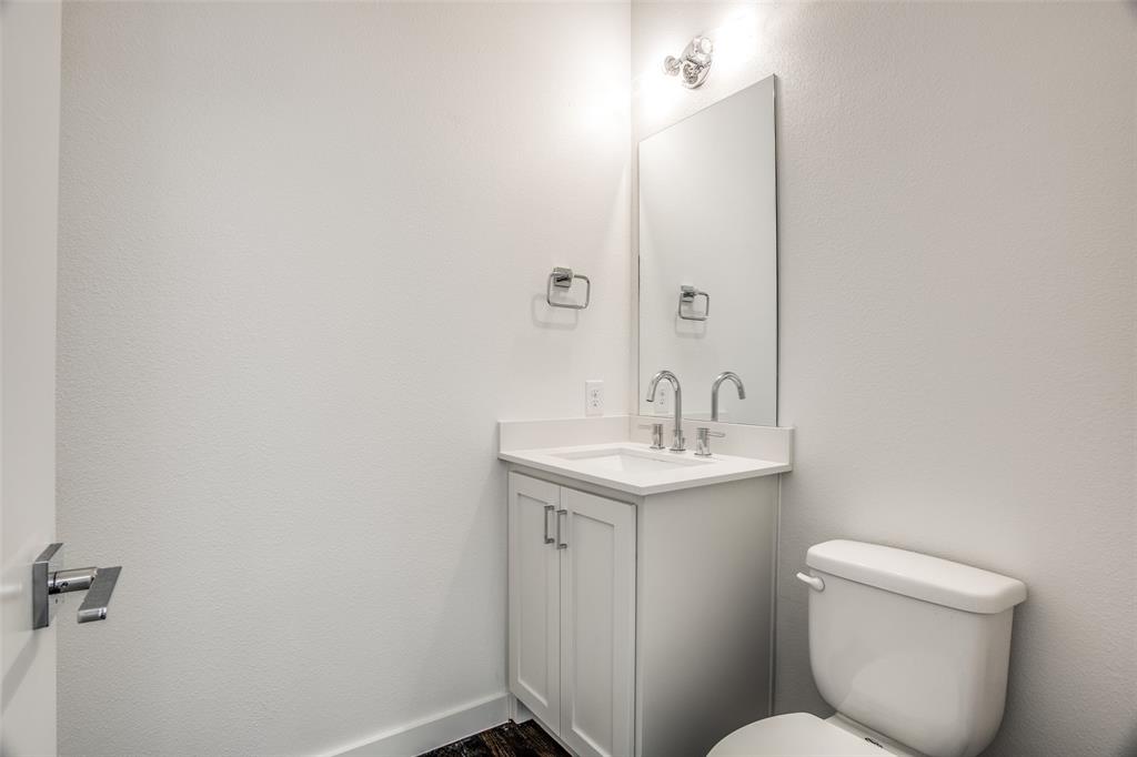 2180 Bennett Avenue, Unit 303 Dallas, TX 75206 - Photo 13 of 24 a bathroom with a toilet sink and mirror