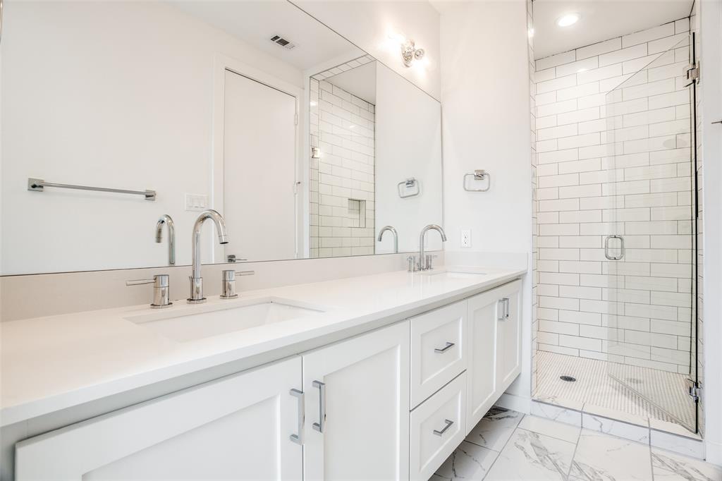 2180 Bennett Avenue, Unit 303 Dallas, TX 75206 - Photo 19 of 24 a bathroom with a double vanity sink a large mirror and shower