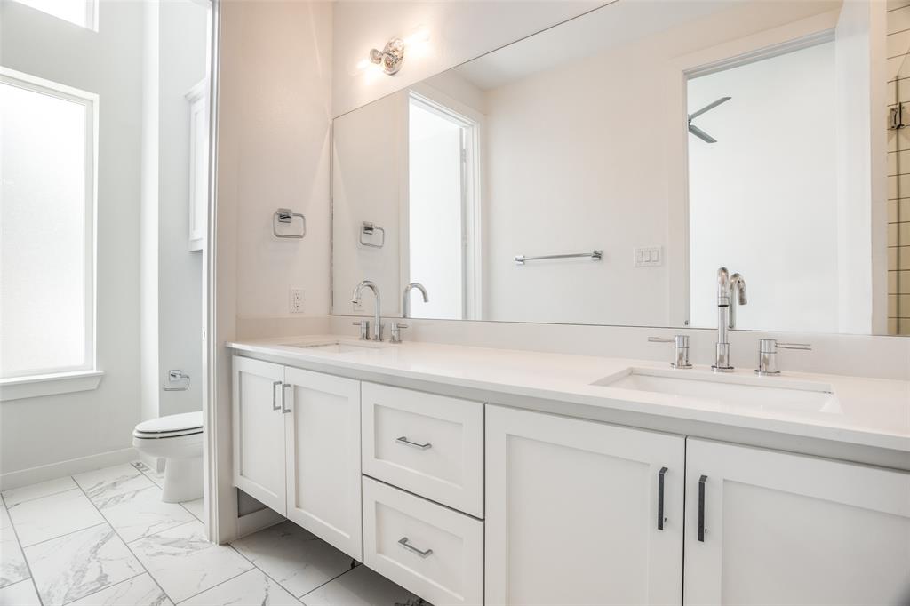 2180 Bennett Avenue, Unit 303 Dallas, TX 75206 - Photo 20 of 24 a bathroom with a granite countertop sink and a mirror
