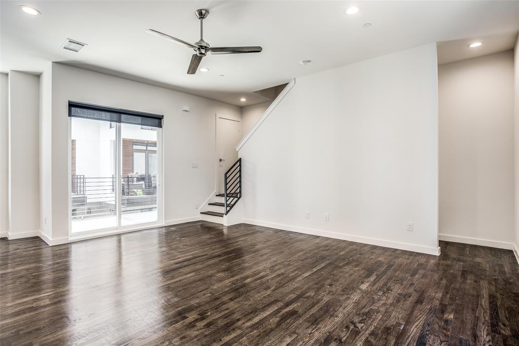 2180 Bennett Avenue, Unit 303 Dallas, TX 75206 - Photo 6 of 24 a view of an empty room with wooden floor and a window
