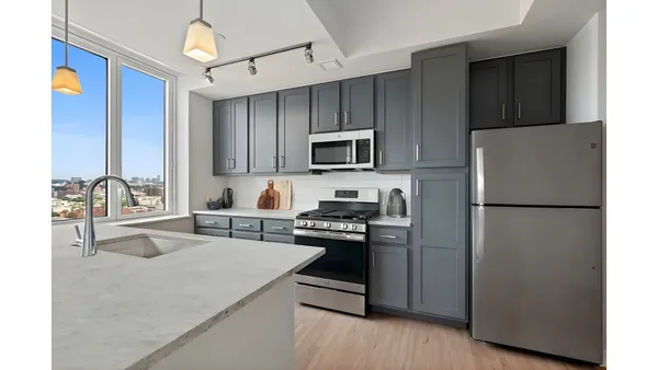 a kitchen with a refrigerator stove and sink