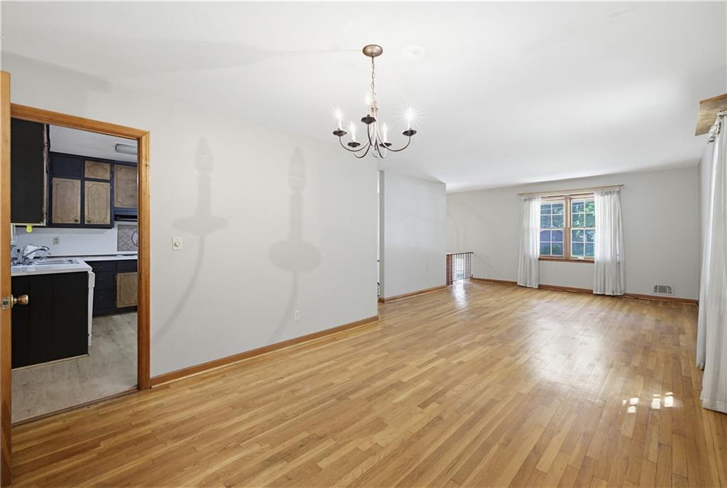 4188 Cedar Valley Lane Conley, GA 30288 - Photo 10 of 28 a view of a room with wooden floor and a ceiling fan