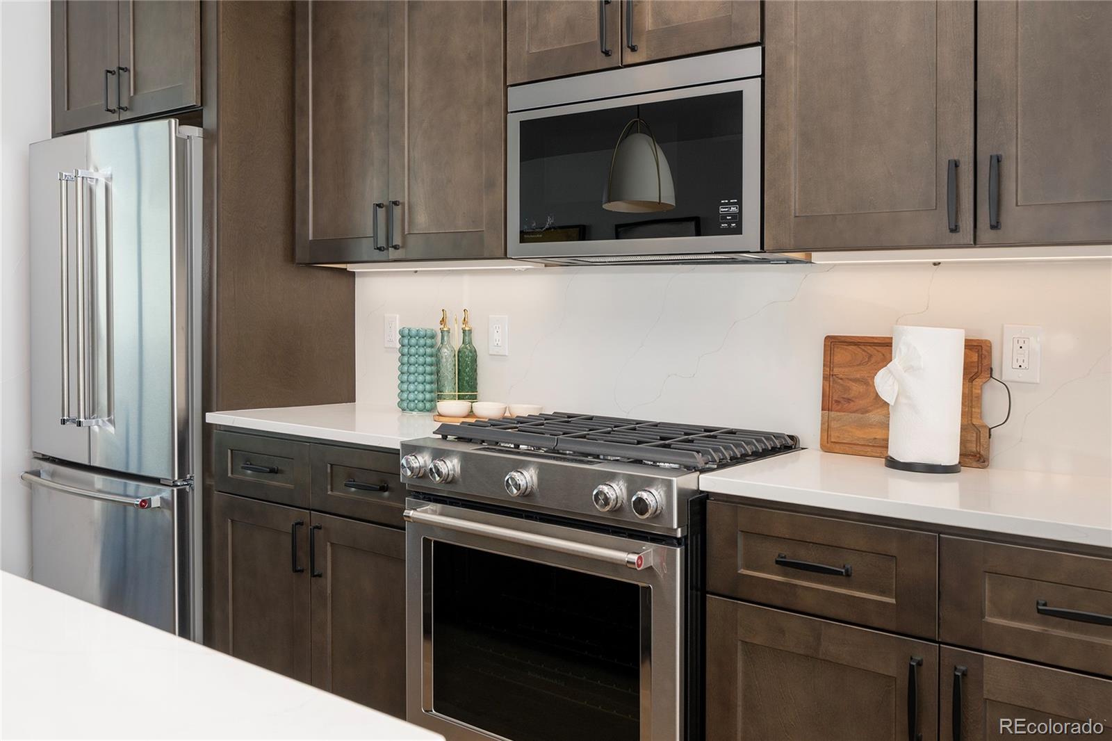 56 Wheeler Road Winter Park, CO 80482 - Photo 12 of 50 a kitchen with stainless steel appliances granite countertop a stove microwave and refrigerator