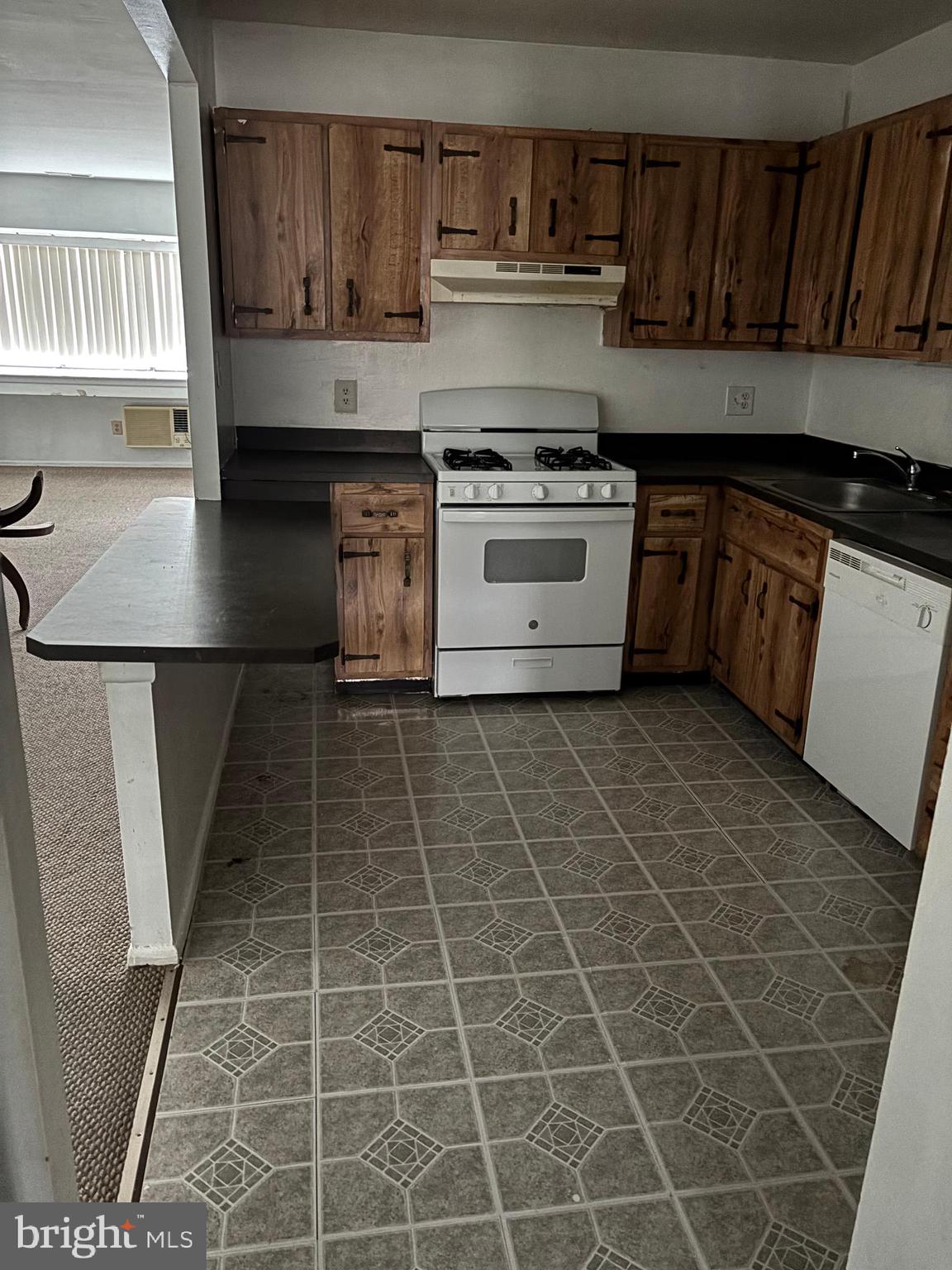 2419 Tremont Street Philadelphia, PA 19115 - Photo 1 of 16 a kitchen with a sink a stove and cabinets