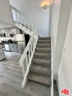 a bedroom with two beds and a flat screen tv