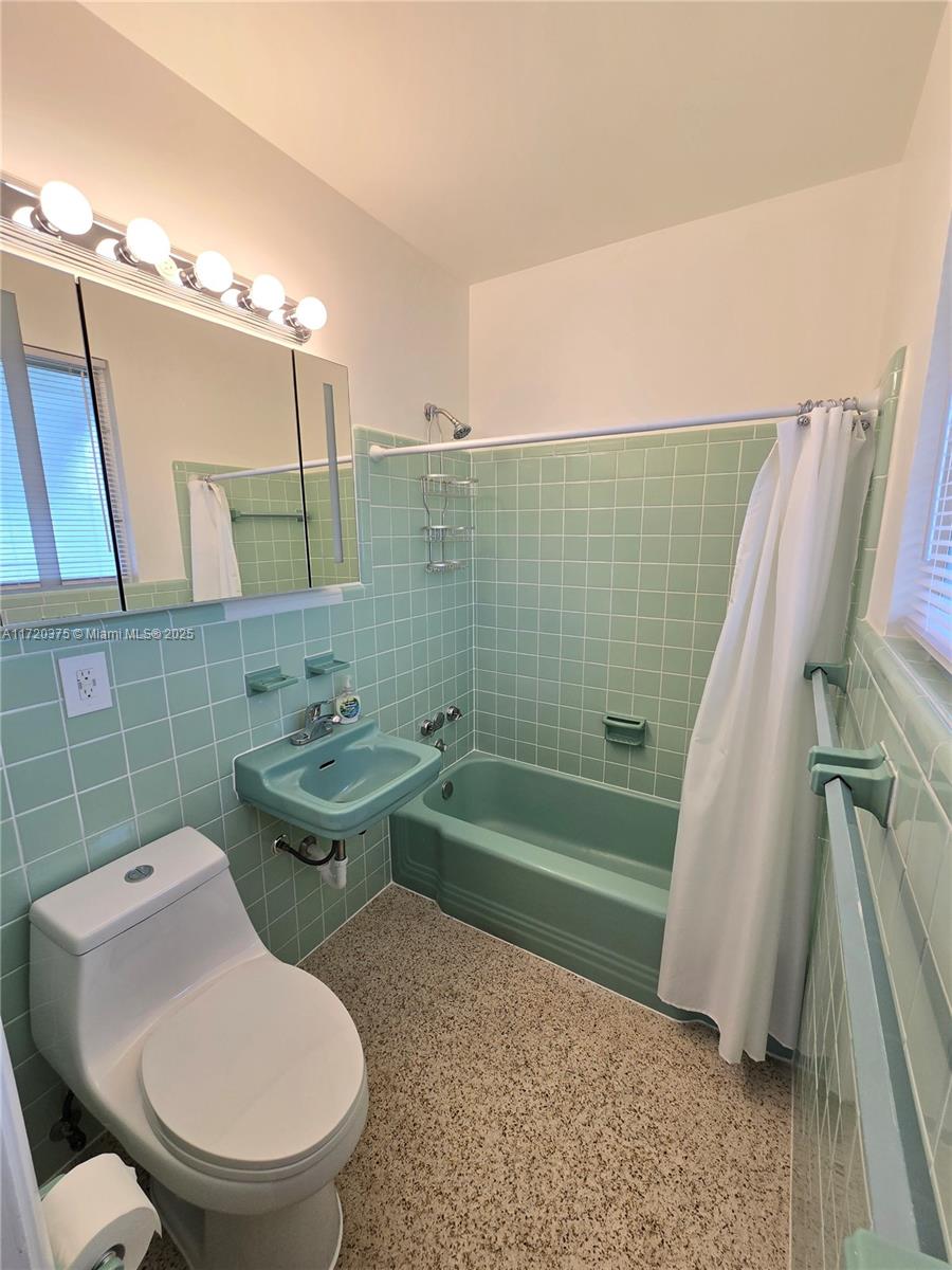 2810 Southwest 24th Terrace, Unit 2 Miami, FL 33145 - Photo 5 of 6 a bathroom with a sink a toilet a mirror and bathtub