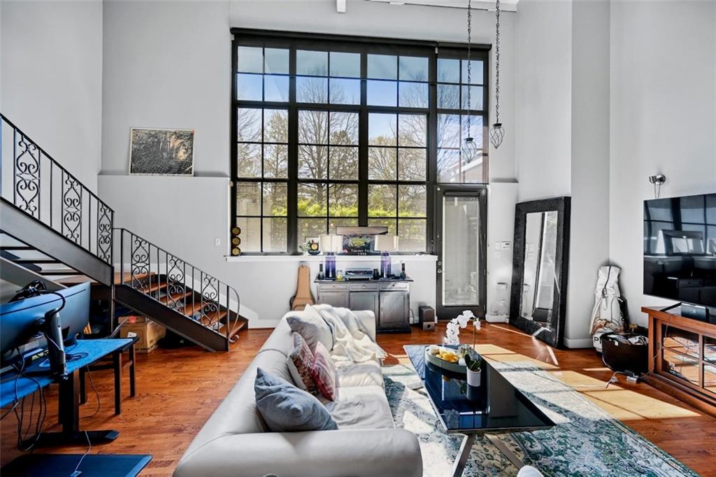 a living room with furniture or window and a wooden floor