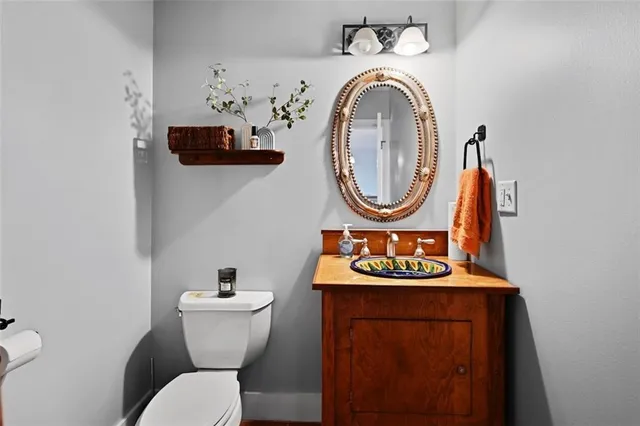 a bathroom with a toilet a sink and a mirror