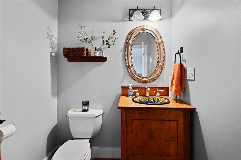 790 North Avenue Northeast, Unit 111 Atlanta, GA 30306 - Photo 13 of 41 a bathroom with a toilet a sink and a mirror