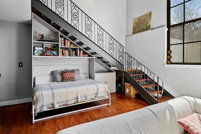 a bedroom with furniture and a book shelf