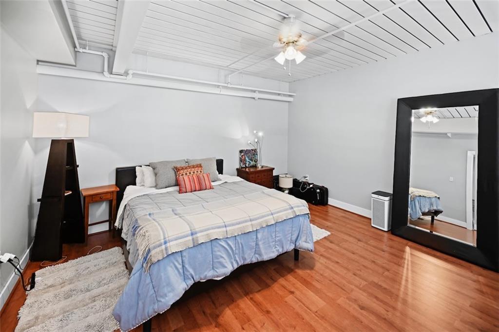 790 North Avenue Northeast, Unit 111 Atlanta, GA 30306 - Photo 16 of 41 a bedroom with bed and wooden floor