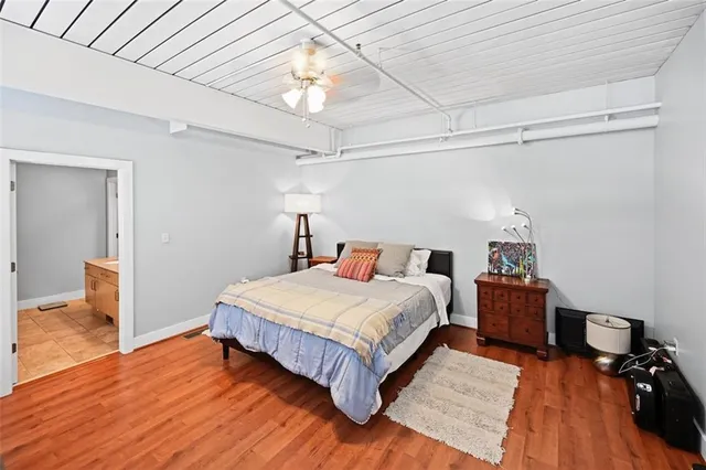 a bedroom with a bed and wooden floor