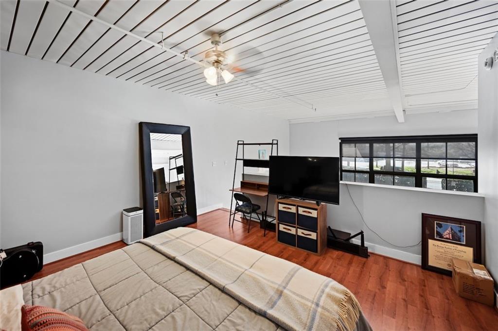 790 North Avenue Northeast, Unit 111 Atlanta, GA 30306 - Photo 18 of 41 a bedroom with a bed and a flat tv screen on a dresser