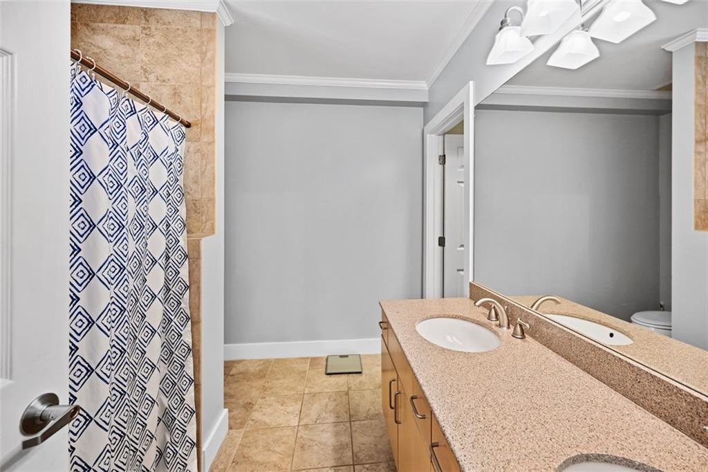 790 North Avenue Northeast, Unit 111 Atlanta, GA 30306 - Photo 20 of 41 a bathroom with a granite countertop sink and a mirror