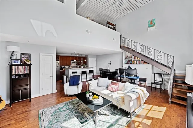 a living room with furniture and a wooden floor