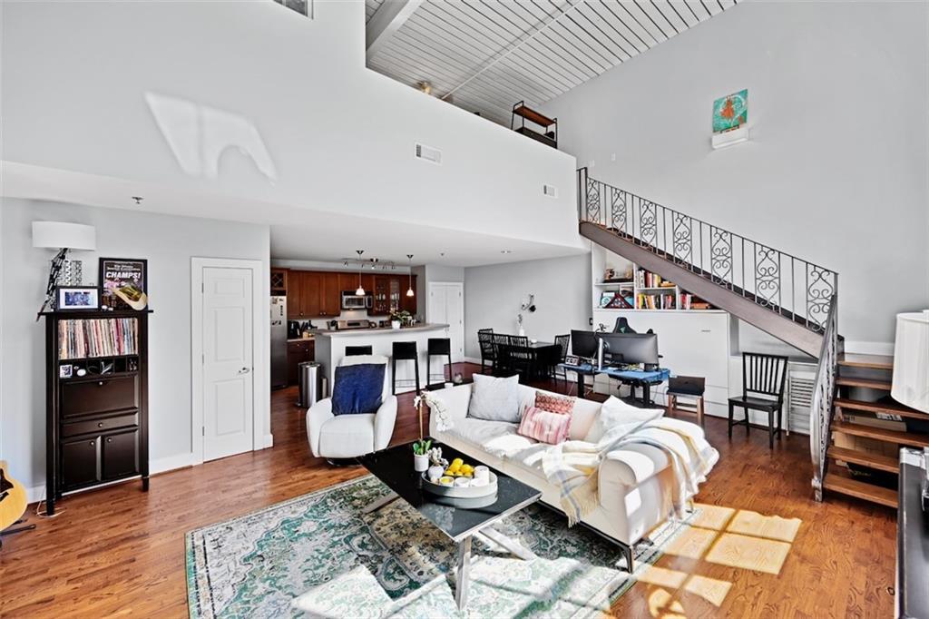 790 North Avenue Northeast, Unit 111 Atlanta, GA 30306 - Photo 7 of 41 a living room with furniture and a wooden floor