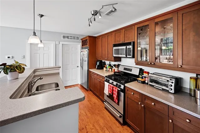 a kitchen with stainless steel appliances granite countertop a sink stove and refrigerator