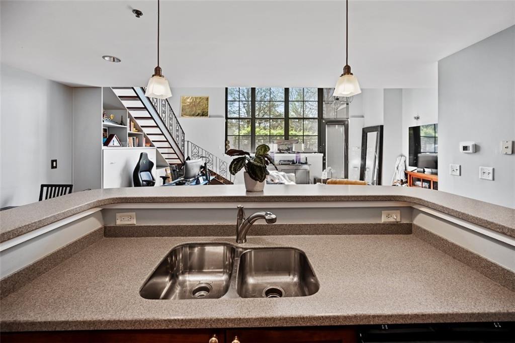 790 North Avenue Northeast, Unit 111 Atlanta, GA 30306 - Photo 10 of 41 a kitchen with a sink and chandelier