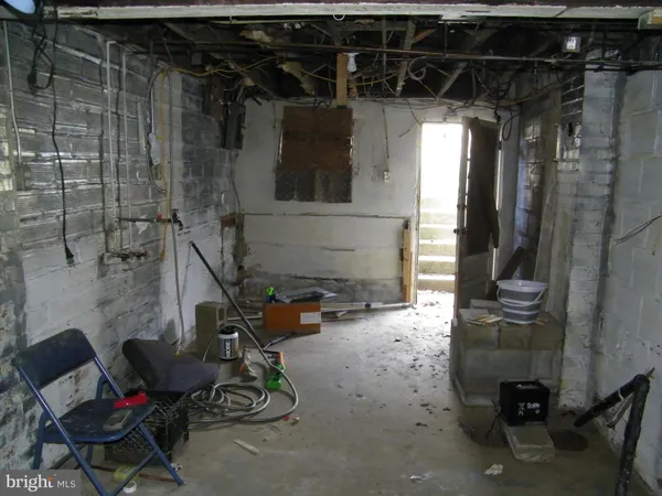 a room with water heater and a wooden door