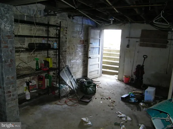 a room with water heater and a wooden shelf