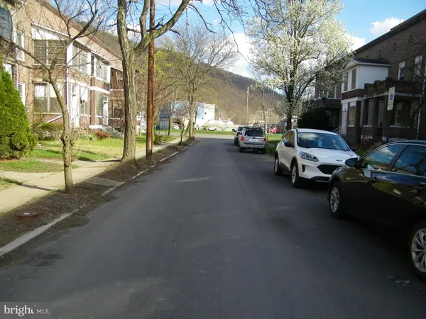 a view of a street with cars