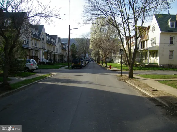 a view of street with parked cars