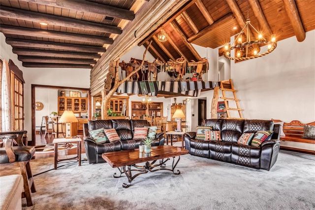 a living room with fireplace furniture and a flat screen tv