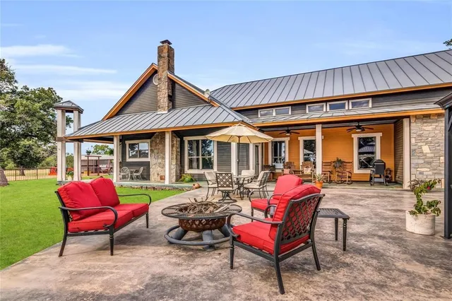 a view of a house with backyard porch and sitting area