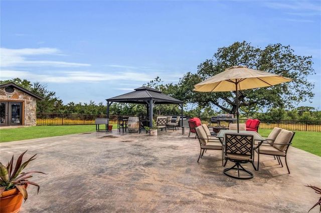 a view of a porch with chairs and backyard