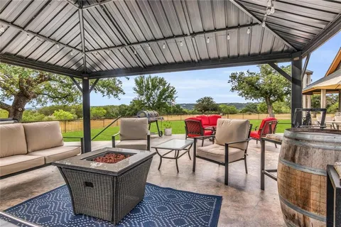 a view of a porch with furniture and garden
