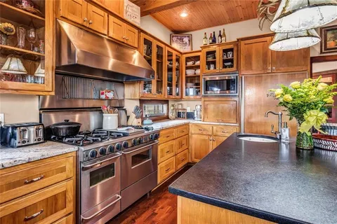 a kitchen with stainless steel appliances granite countertop a sink and cabinets