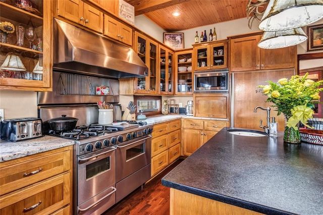 a kitchen with stainless steel appliances granite countertop a sink and cabinets