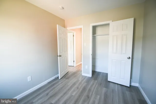 a view of hallway with wooden floor