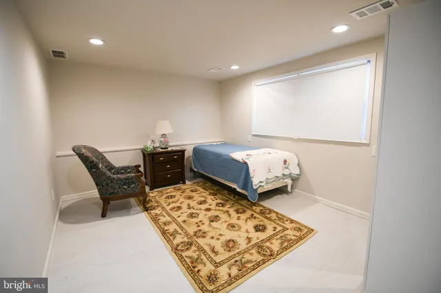 a bedroom with bed and a window