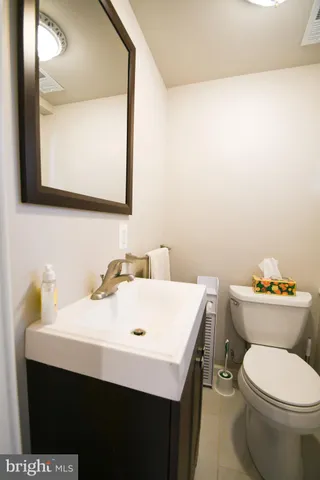 a bathroom with a sink a toilet and mirror