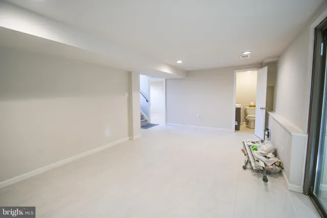 an empty room with wooden floor and furniture