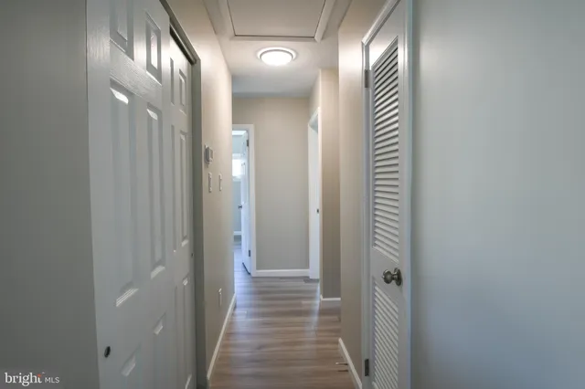 a view of a hallway with wooden floor