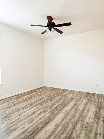 a view of a room with wooden floor