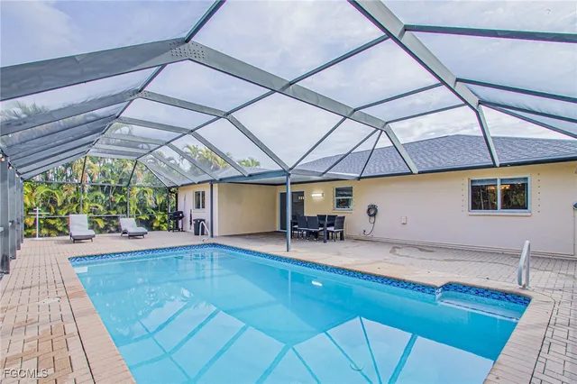 a room with pool table and windows