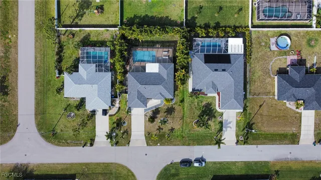 an aerial view of a house with a yard basket ball court and outdoor seating