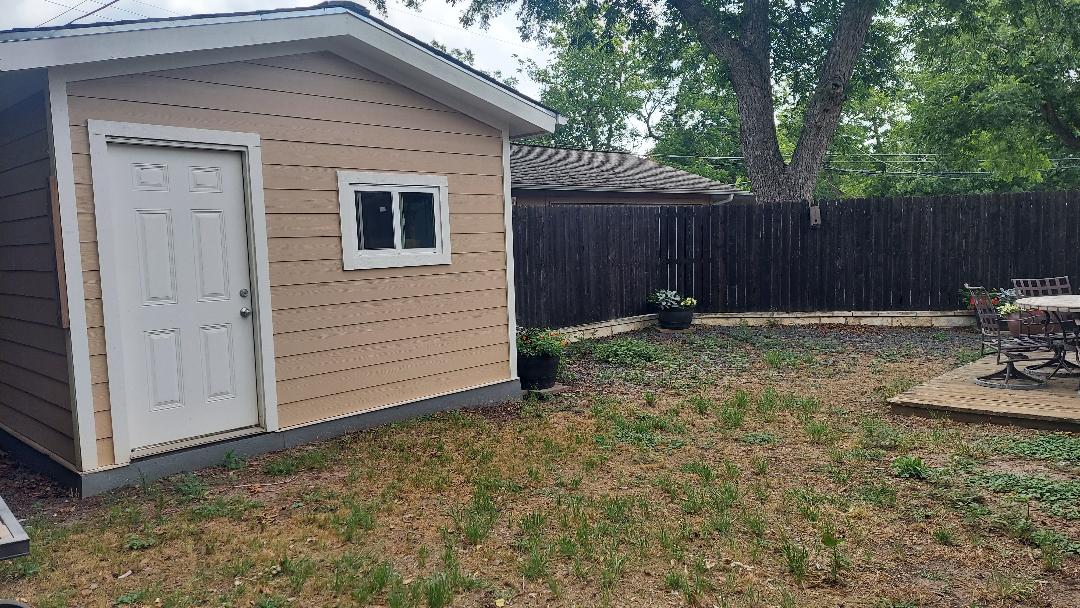 1807 Barbara Street Austin, TX 78757 - Photo 3 of 25 a backyard of a house with chairs and wooden fence