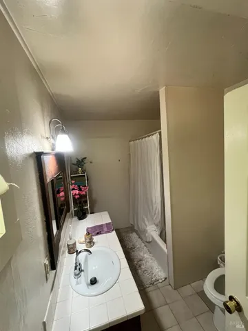 a bedroom with bed and a large mirror