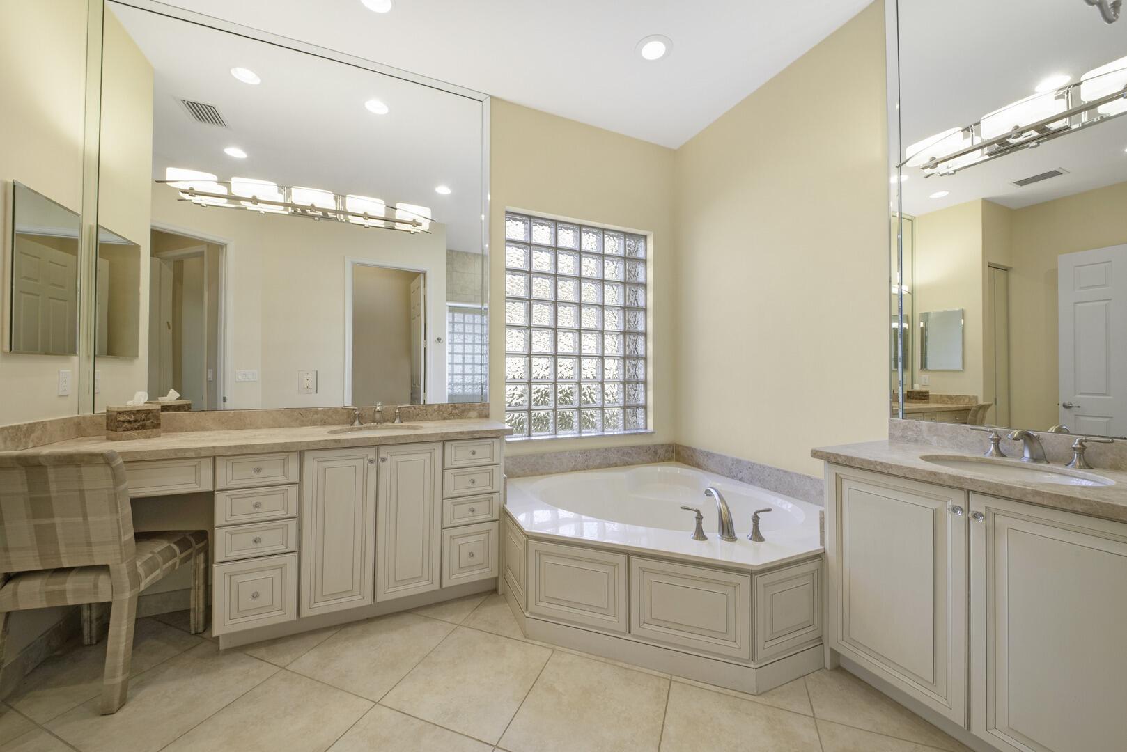 8289 Razorback Court Boynton Beach, FL 33473 - Photo 21 of 51 a bathroom with a tub a sink and mirrors