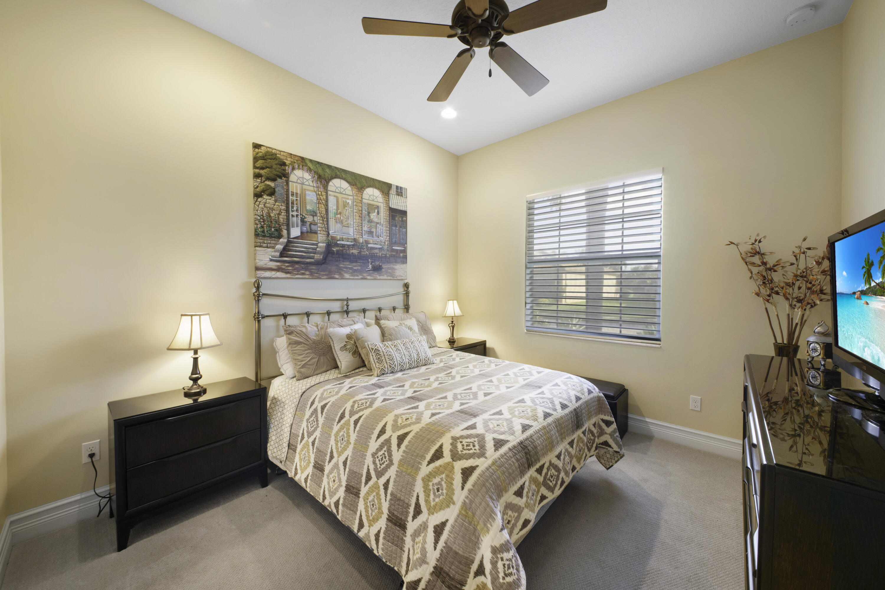 8289 Razorback Court Boynton Beach, FL 33473 - Photo 23 of 51 a bedroom with a bed a couch and a flat tv screen