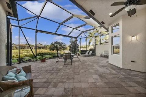 a view of a porch with furniture and a yard