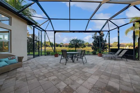 a view of a chairs and table in the back yard of the house