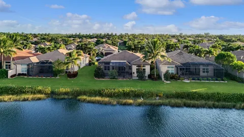 an aerial view of a house with a garden and lake view