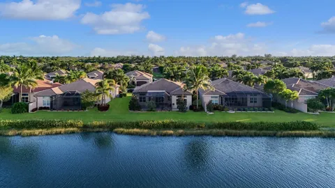 an aerial view of a house with yard and lake view