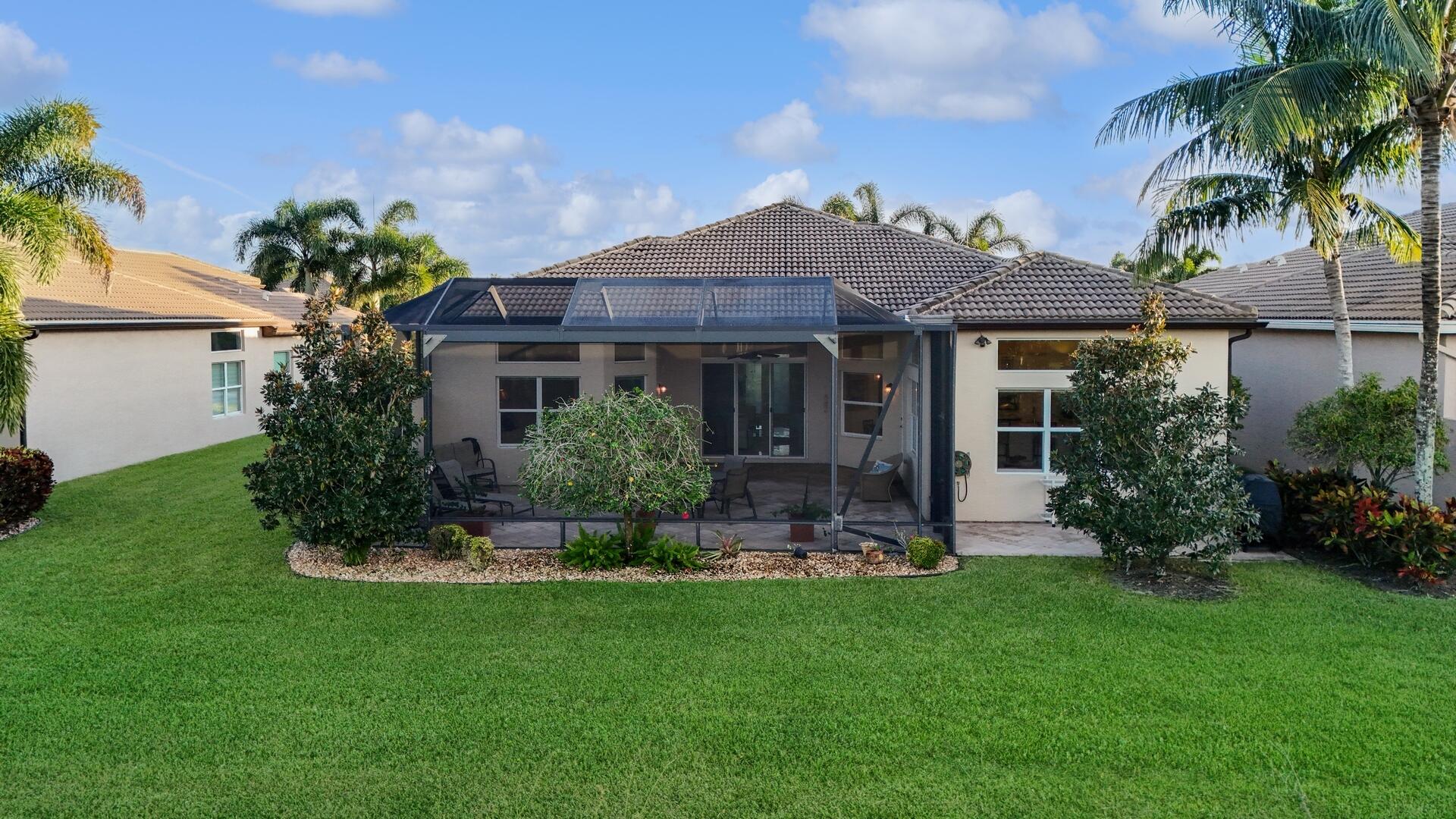 8289 Razorback Court Boynton Beach, FL 33473 - Photo 38 of 51 a front view of a house with a yard and potted plants
